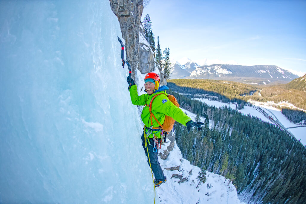 person smiling while on an ice wall in the Canadian Rockies