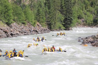 five boats enjoying kicking horse river rafting in Golden BC